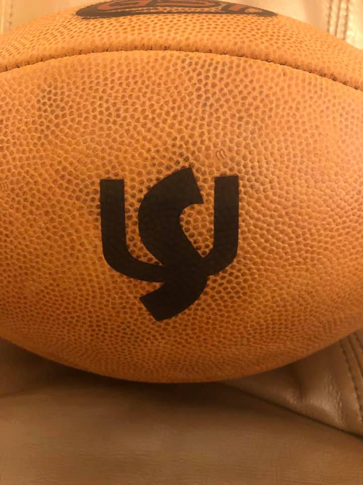 Regulation sized college football engraved with a custom logo for Shepherd University.